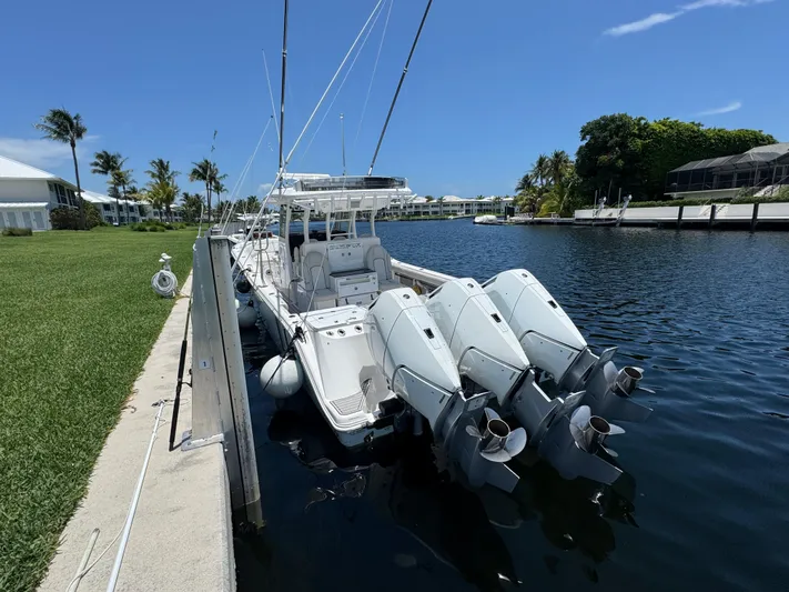  Yacht Photos Pics 2023 Sea Fox 368 Commander docked with triple outboard engines, under clear blue sky.