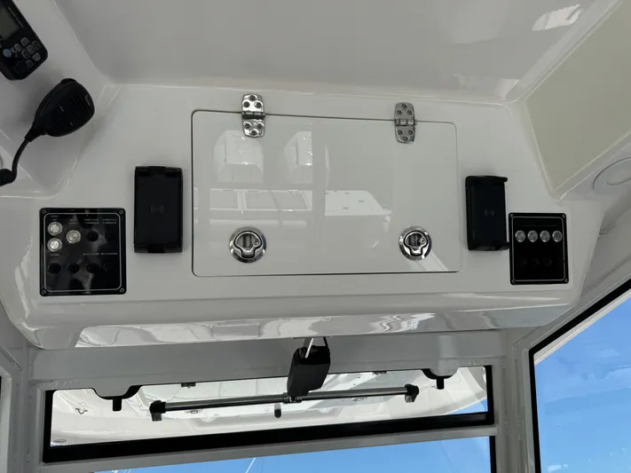  Yacht Photos Pics Control panel of a 2023 Sea Fox 368 Commander boat, featuring switches and storage compartments.