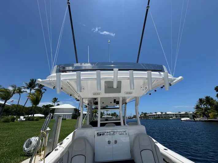  Yacht Photos Pics 2023 Sea Fox 368 Commander boat docked by a scenic waterfront.