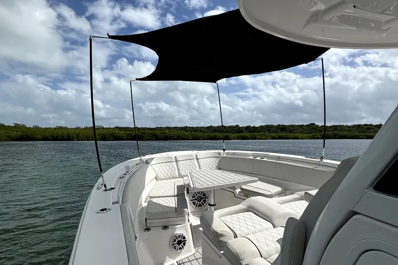  Yacht Photos Pics 2023 Sea Fox 368 Commander boat with shaded seating area on calm water.