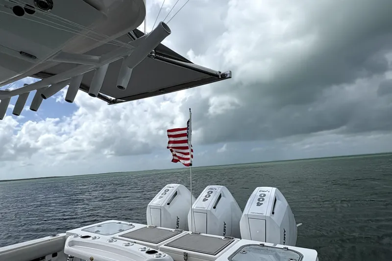  Yacht Photos Pics 2023 Sea Fox 368 Commander boat with triple Mercury engines and American flag on open water.