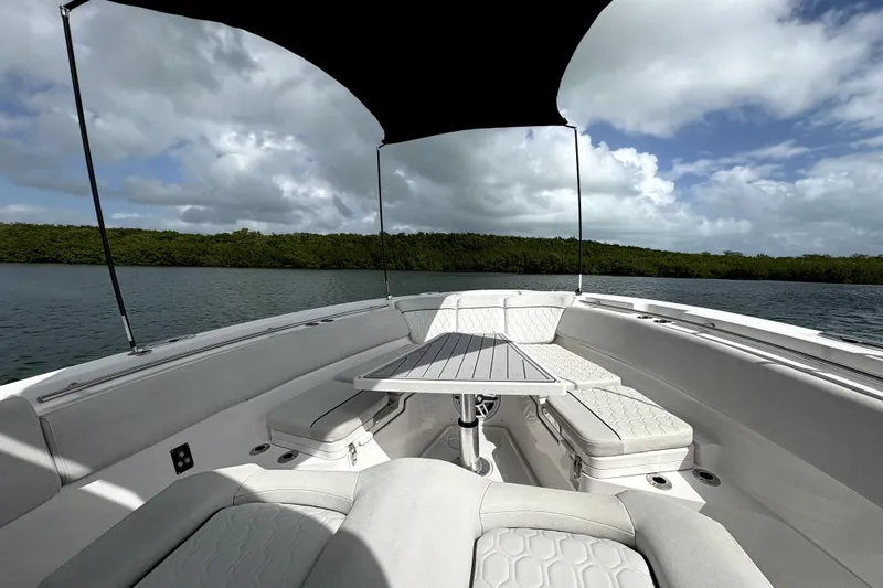  Yacht Photos Pics 2023 Sea Fox 368 Commander boat interior with seating and table under canopy on water.