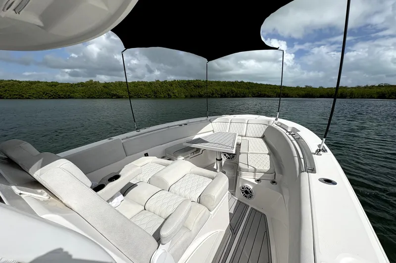  Yacht Photos Pics 2023 Sea Fox 368 Commander boat interior with seating and canopy on a calm lake.