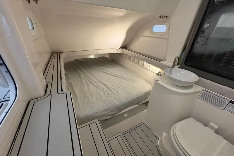  Yacht Photos Pics 2023 Sea Fox 368 Commander cabin interior with bed, sink, and toilet.