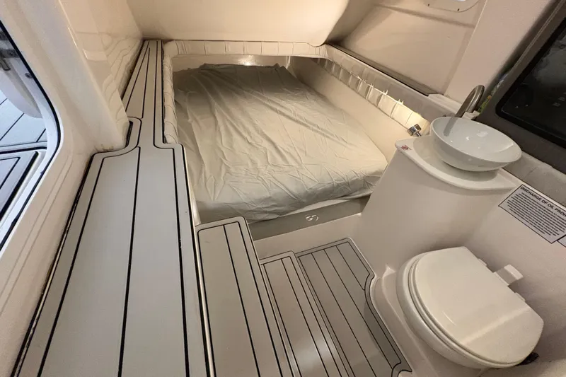  Yacht Photos Pics 2023 Sea Fox 368 Commander cabin interior with bed, sink, and toilet.