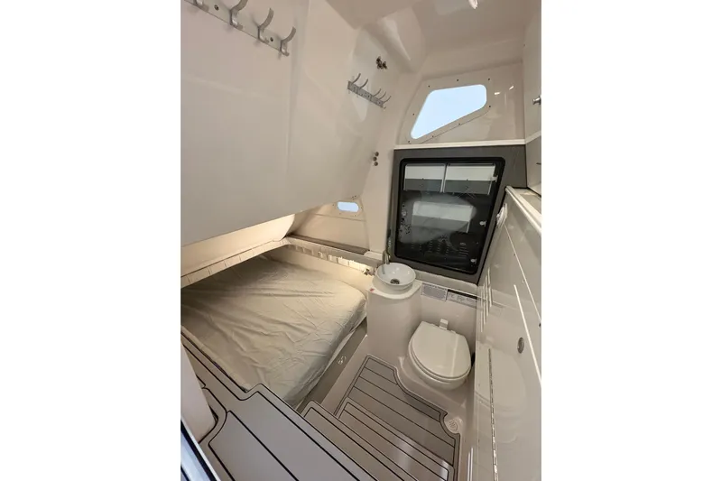  Yacht Photos Pics 2023 Sea Fox 368 Commander cabin interior with bed, toilet, and sink.