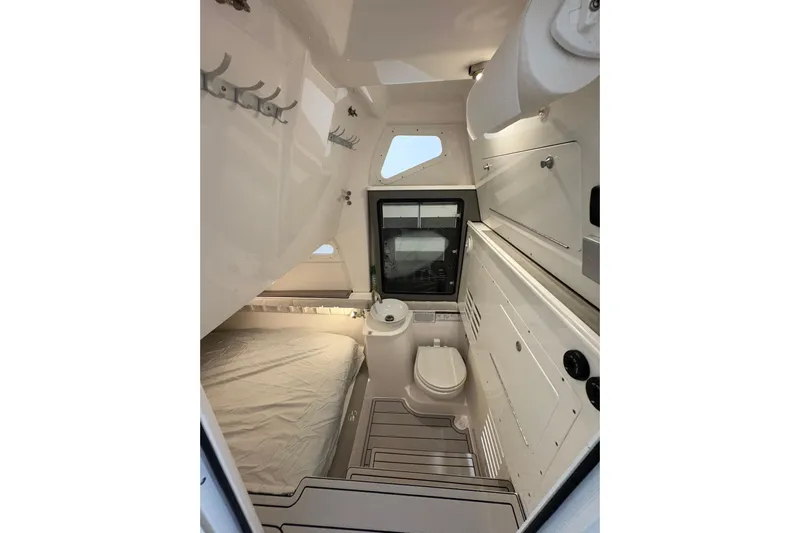  Yacht Photos Pics 2023 Sea Fox 368 Commander cabin interior with bed, toilet, and storage.