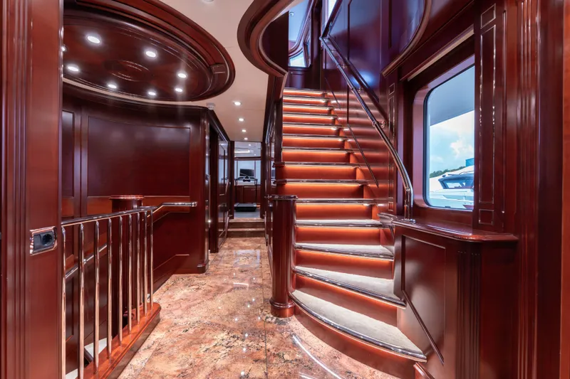 Beothuk Yacht Photos Pics Luxurious interior of 2008 Kuipers Woudsend Doggersbank Offshore yacht with elegant wooden staircase.
