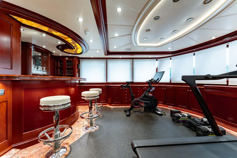 Beothuk Yacht Photos Pics Luxurious yacht interior with bar, exercise equipment, and elegant wood paneling, 2008 Kuipers Woudsend Doggersbank Offshore.