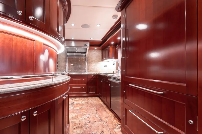 Beothuk Yacht Photos Pics Luxurious yacht kitchen with rich wood cabinetry, stainless steel appliances, and elegant lighting, 2008 model.