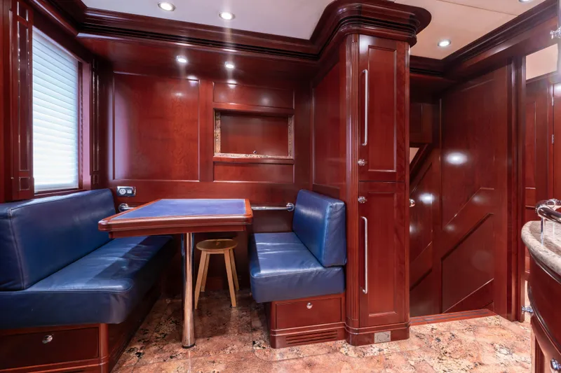 Beothuk Yacht Photos Pics Luxurious wooden interior of 2008 Kuipers Woudsend Doggersbank Offshore yacht with blue seating.