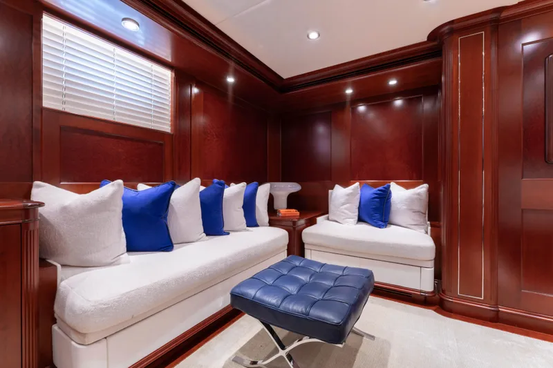 Beothuk Yacht Photos Pics Luxurious yacht interior with plush seating, blue and white cushions, and rich wood paneling.