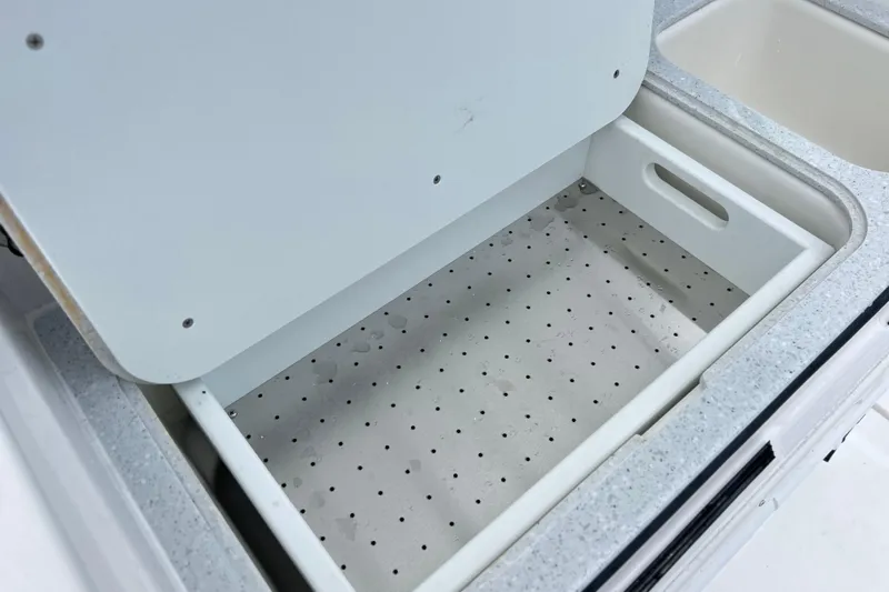  Yacht Photos Pics Open storage compartment on 2026 Sea Fox 328 Commander boat, featuring a perforated tray.
