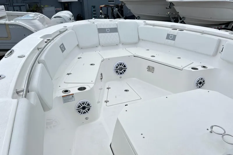  Yacht Photos Pics 2026 Sea Fox 328 Commander boat interior with white seating and built-in speakers.