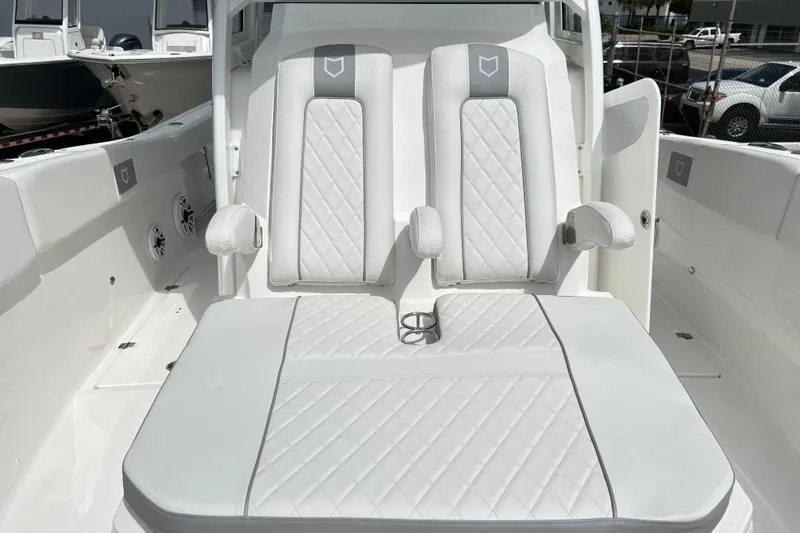  Yacht Photos Pics 2026 Sea Fox 328 Commander boat interior with white cushioned seating and armrests.
