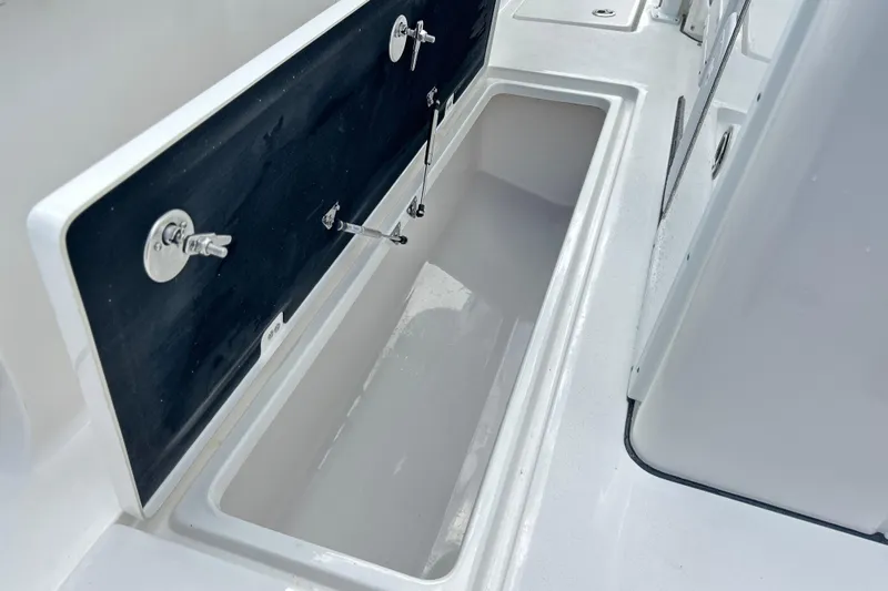  Yacht Photos Pics 2026 Sea Fox 328 Commander storage compartment with open lid, showcasing interior space.