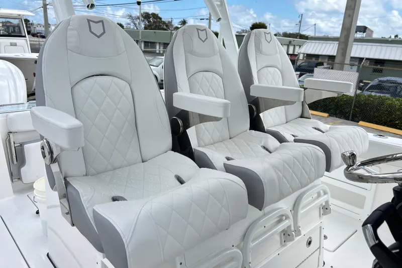  Yacht Photos Pics Luxurious seating on 2026 Sea Fox 328 Commander boat, featuring elegant white upholstery.