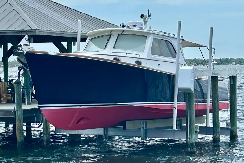 Clarity Yacht Photos Pics 2006 Hinckley 36 EP Picnic Boat docked on a lift by the water.