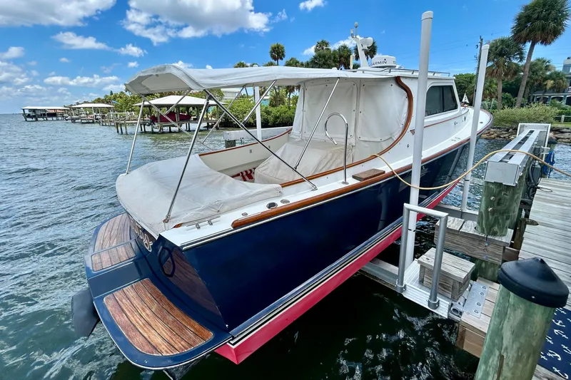 Clarity Yacht Photos Pics 2006 Hinckley 36 EP Picnic Boat docked by the water under a clear sky.