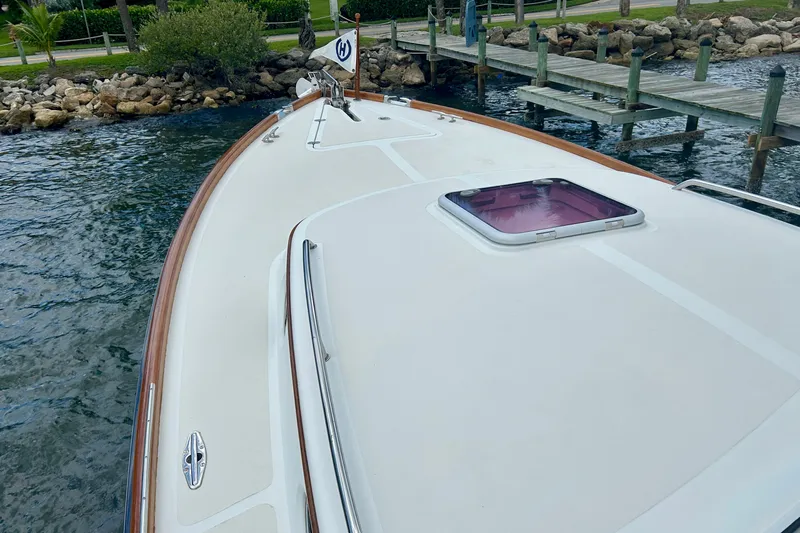 Clarity Yacht Photos Pics 2006 Hinckley 36 EP Picnic Boat docked by a wooden pier.