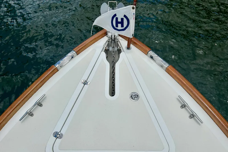 Clarity Yacht Photos Pics Bow of 2006 Hinckley 36 EP Picnic Boat with anchor chain and flag on water.