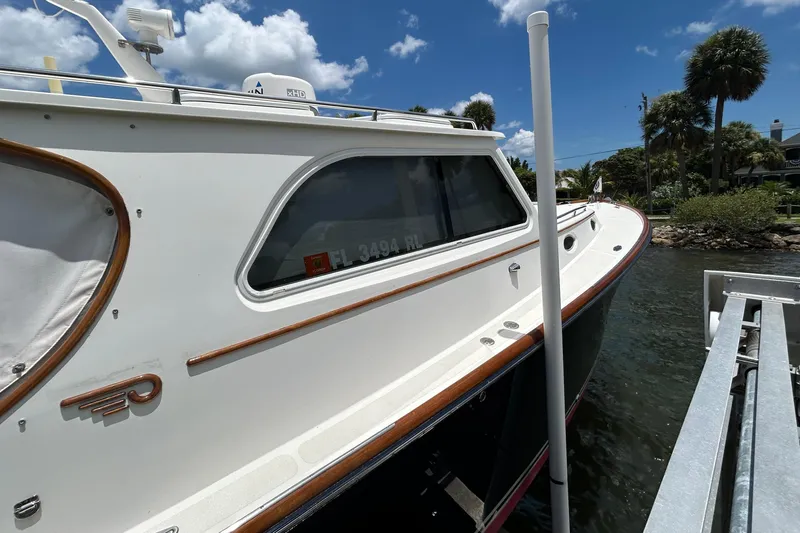 Clarity Yacht Photos Pics 2006 Hinckley 36 EP Picnic Boat docked under a clear blue sky.