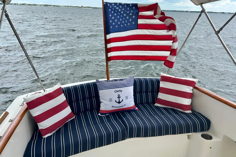 Clarity Yacht Photos Pics Hinckley 36 EP Picnic Boat 2006 with American flag and striped cushions on deck.