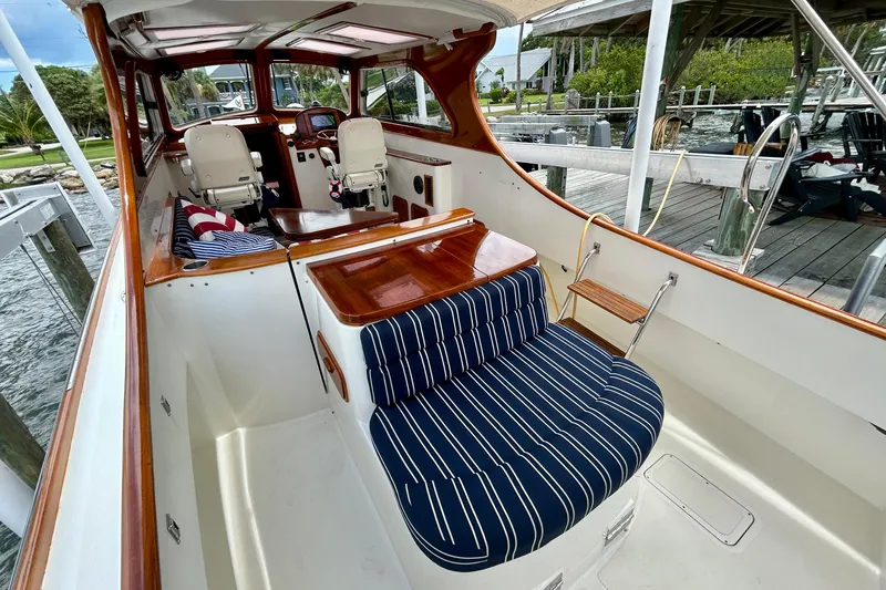 Clarity Yacht Photos Pics 2006 Hinckley 36 EP Picnic Boat interior with striped seating and wooden accents.
