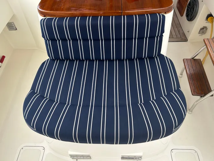 Clarity Yacht Photos Pics Blue striped cushioned seat on 2006 Hinckley 36 EP Picnic Boat.