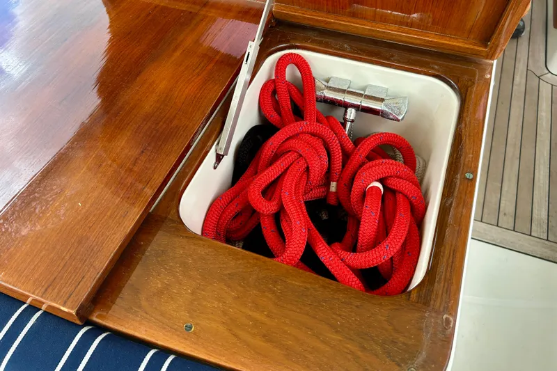 Clarity Yacht Photos Pics Red rope stored in a wooden compartment on a 2006 Hinckley 36 EP Picnic Boat.