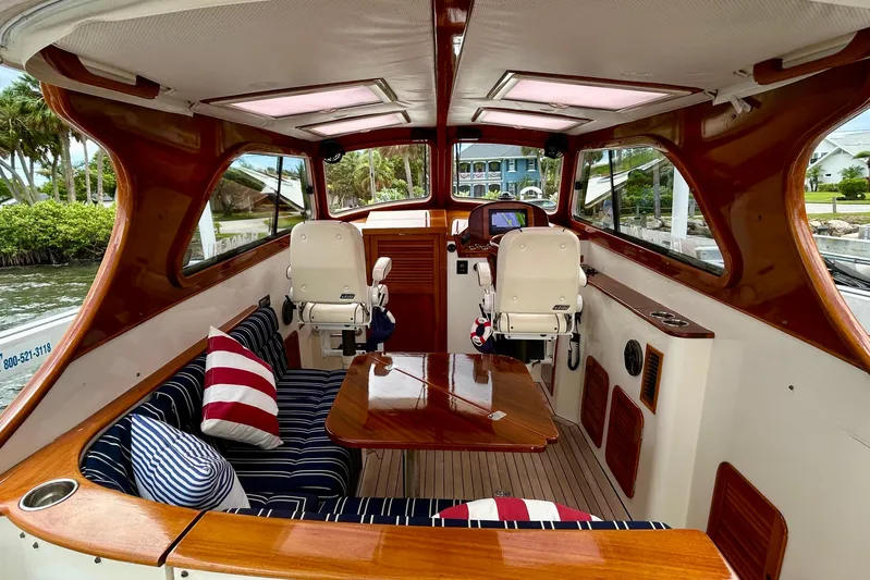 Clarity Yacht Photos Pics Interior of 2006 Hinckley 36 EP Picnic Boat with wood finish and striped cushions.