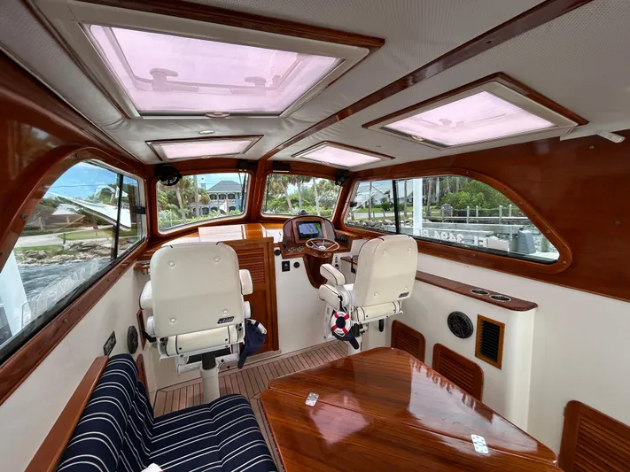 Clarity Yacht Photos Pics Interior of a 2006 Hinckley 36 EP Picnic Boat with wooden accents and seating.