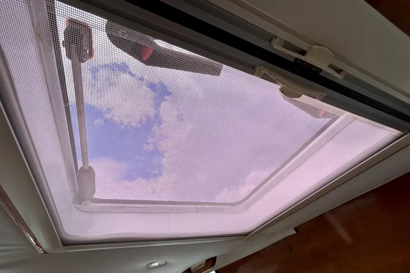 Clarity Yacht Photos Pics Skylight view from 2006 Hinckley 36 EP Picnic Boat, showcasing blue sky and clouds.