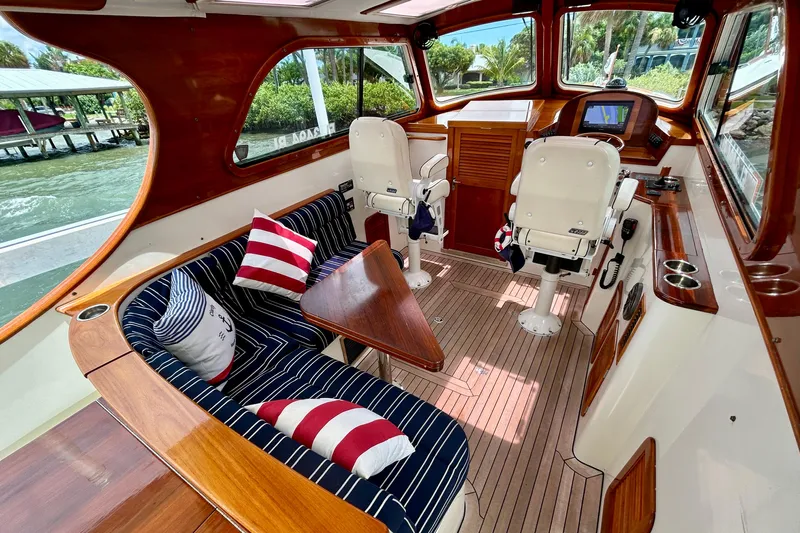 Clarity Yacht Photos Pics Interior of a 2006 Hinckley 36 EP Picnic Boat with striped seating and wooden accents.