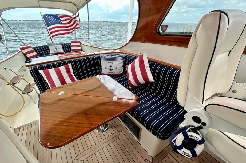 Clarity Yacht Photos Pics 2006 Hinckley 36 EP Picnic Boat interior with striped cushions and American flag.