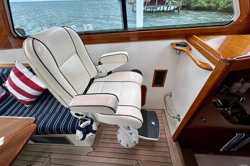 Clarity Yacht Photos Pics Luxurious interior of 2006 Hinckley 36 EP Picnic Boat with plush seating and nautical decor.