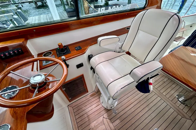 Clarity Yacht Photos Pics Captain's chair and helm of 2006 Hinckley 36 EP Picnic Boat with wooden accents.