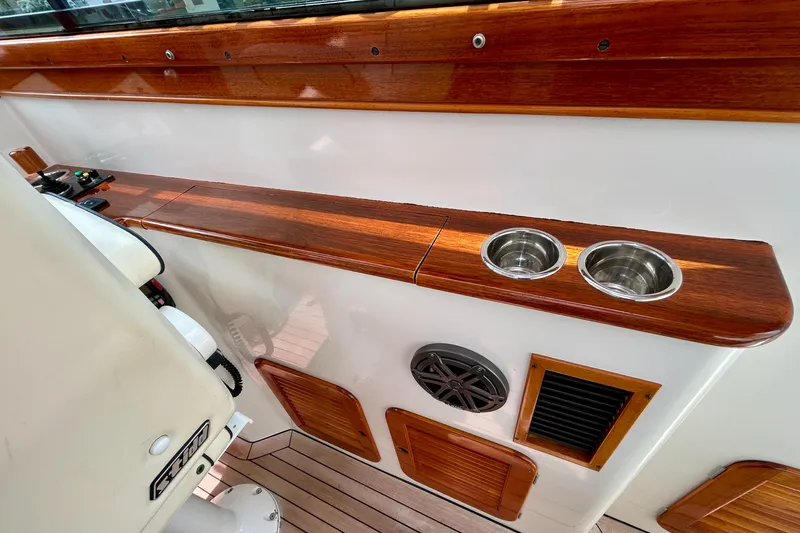 Clarity Yacht Photos Pics Interior of 2006 Hinckley 36 EP Picnic Boat with wood trim and cup holders.
