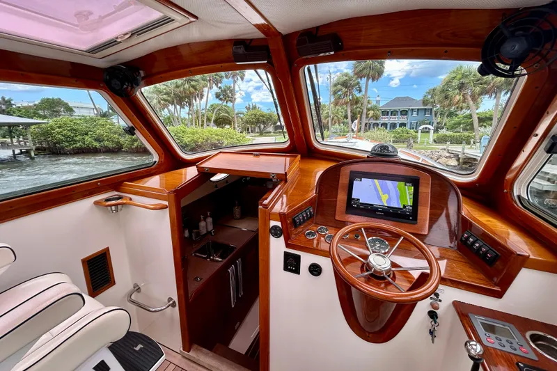 Clarity Yacht Photos Pics Interior of 2006 Hinckley 36 EP Picnic Boat with wooden dashboard and navigation system.