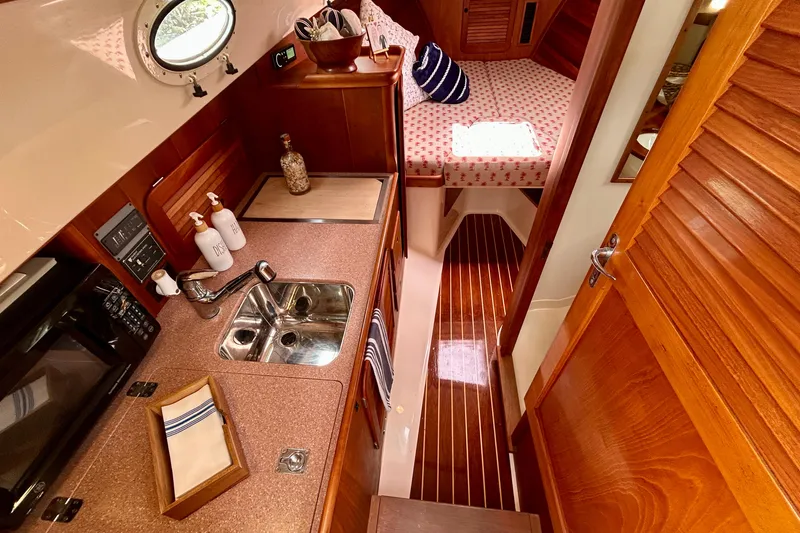 Clarity Yacht Photos Pics Interior of 2006 Hinckley 36 EP Picnic Boat with kitchenette and cozy sleeping area.