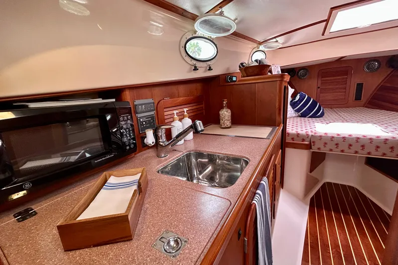 Clarity Yacht Photos Pics Interior of 2006 Hinckley 36 EP Picnic Boat with kitchenette and cozy sleeping area.