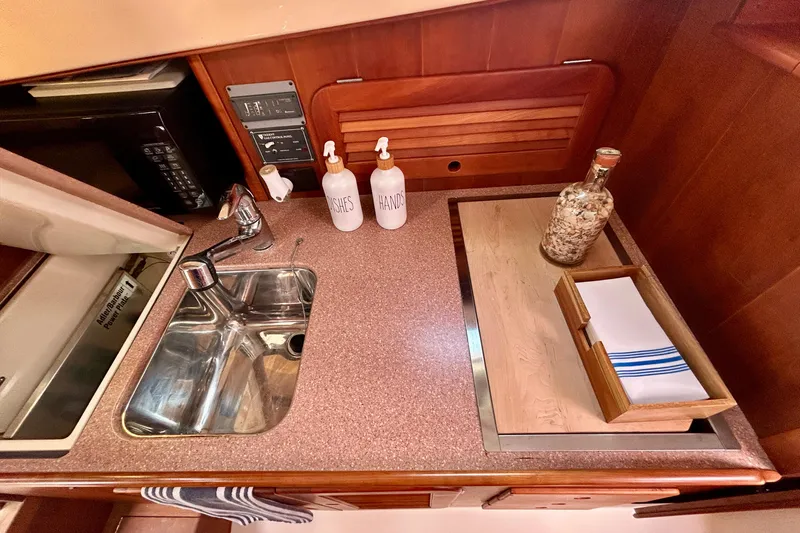 Clarity Yacht Photos Pics 2006 Hinckley 36 EP Picnic Boat galley with sink, countertop, and storage.