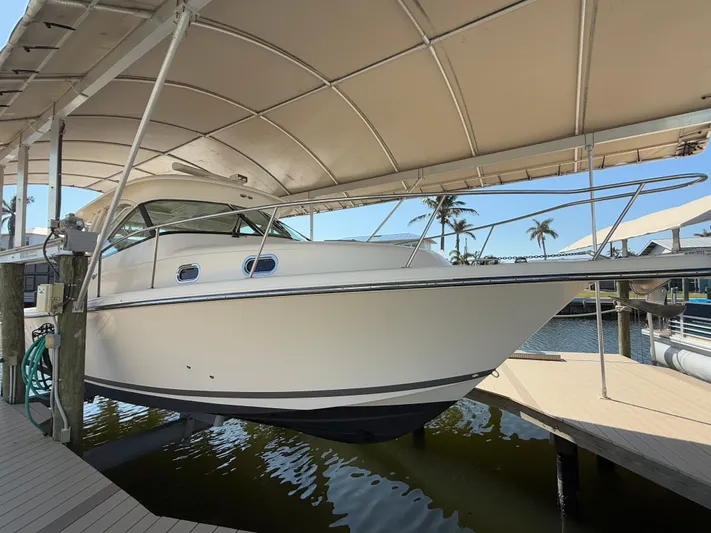  Yacht Photos Pics 2011 Pursuit OS 345 Offshore boat docked under a canopy.