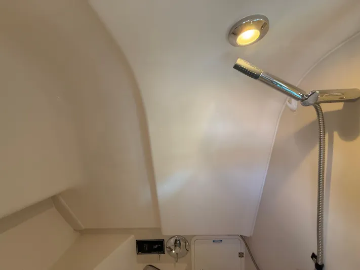  Yacht Photos Pics Interior of 2011 Pursuit OS 345 Offshore boat with shower and light fixture.