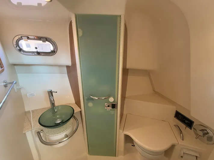  Yacht Photos Pics 2011 Pursuit OS 345 Offshore boat bathroom with modern sink and toilet.