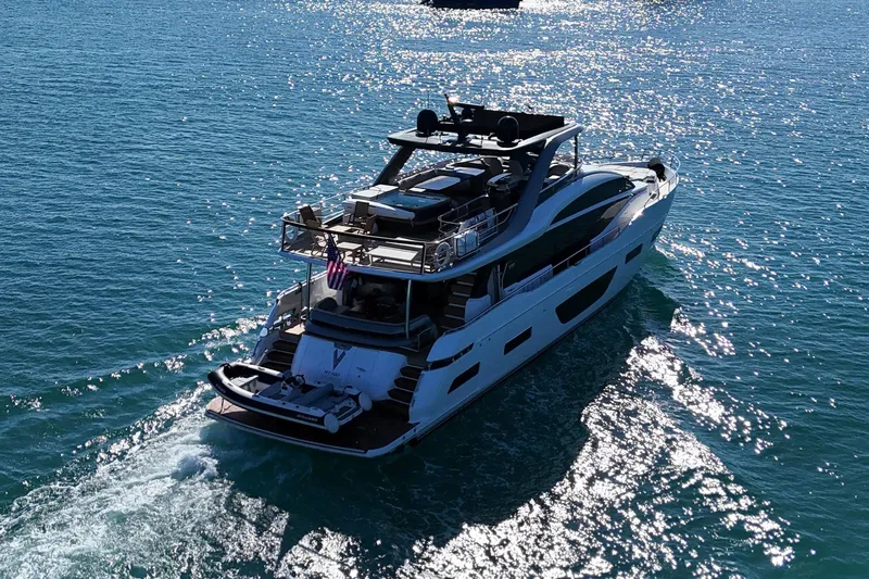  Yacht Photos Pics Luxurious 2022 Princess Y85 yacht cruising on sparkling blue water.