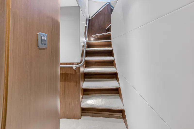  Yacht Photos Pics Staircase inside 2022 Princess Y85 yacht, featuring sleek wood and modern design.