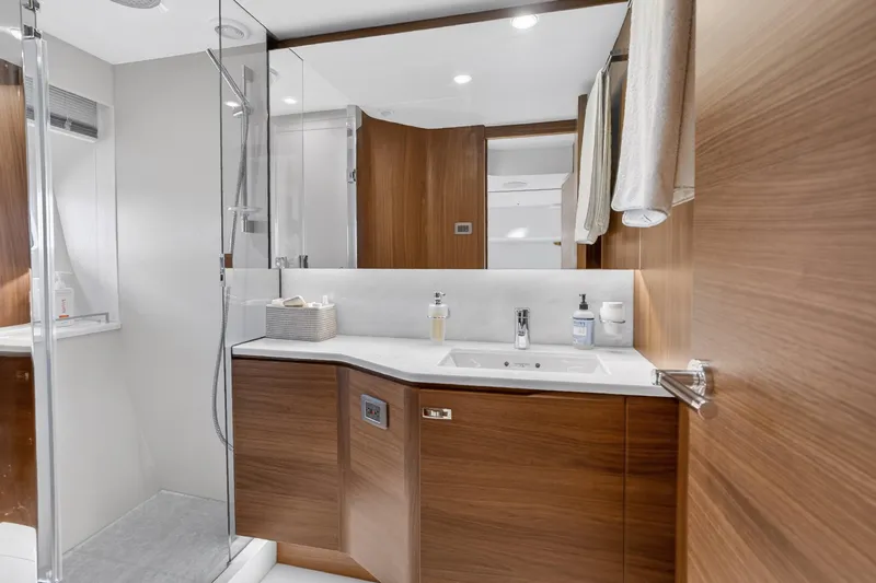  Yacht Photos Pics Luxurious bathroom interior of 2022 Princess Y85 yacht with modern wood finishes.