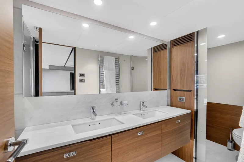  Yacht Photos Pics Luxurious bathroom interior on 2022 Princess Y85 yacht, featuring dual sinks and modern design.