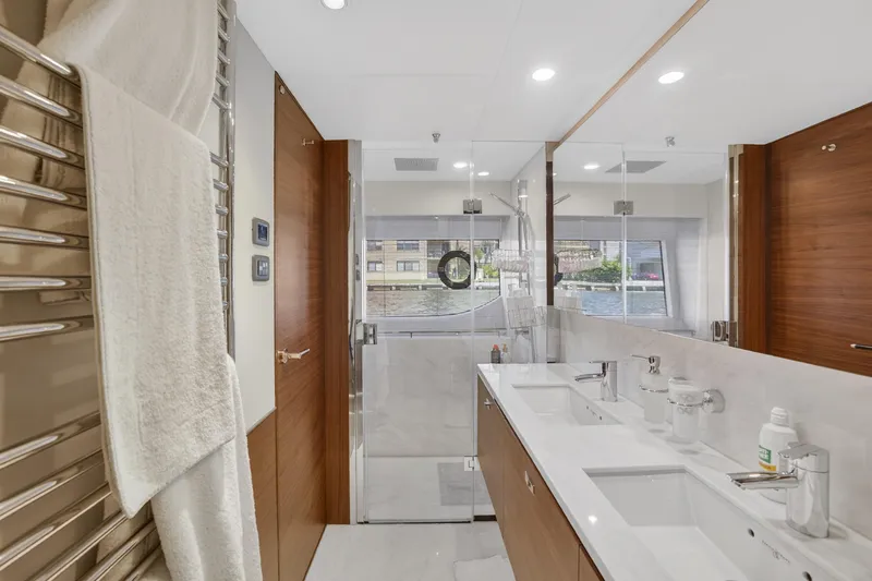  Yacht Photos Pics Luxurious bathroom interior on 2022 Princess Y85 yacht, featuring dual sinks and glass shower.